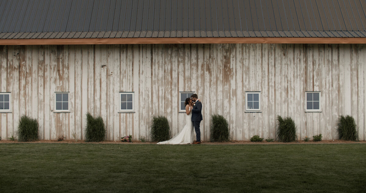 Bride and groom at Countryside Barn, captured by Prairie Orchid Weddings, wedding videographers in Lethbridge, Alberta. Featured on the Bronte Bride Vendor Guide.
