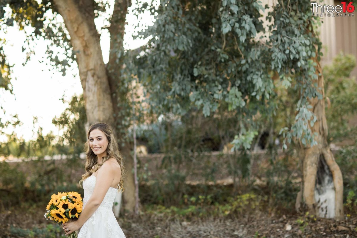 Bride posing in the woods area