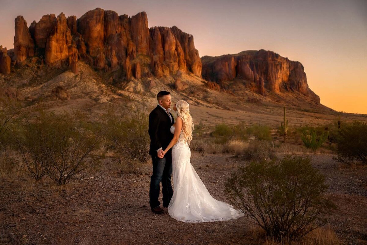 Bride and groom holding hands at lost dutchman state park during Elopement