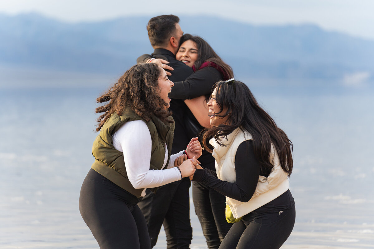 A couple celebrating with their family after getting engaged