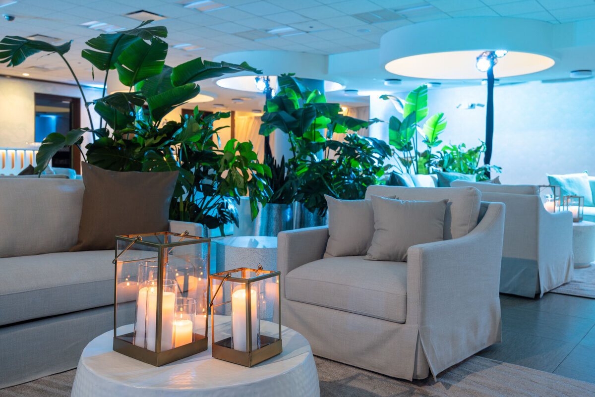 Lounge chair with candles and lush greenery