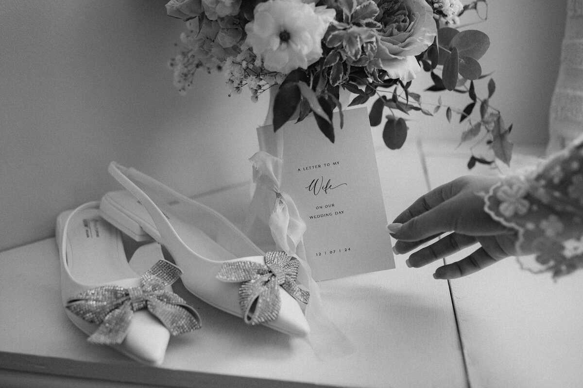 detail photo of bride reching for vow book