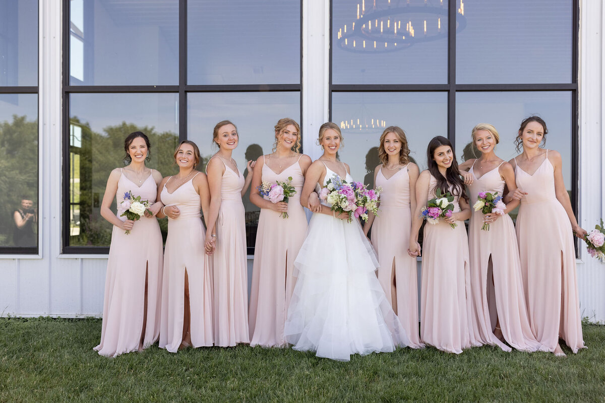 Bridesmaids in matching dresses with soft glam makeup and elegant hairstyles in Madison, WI.