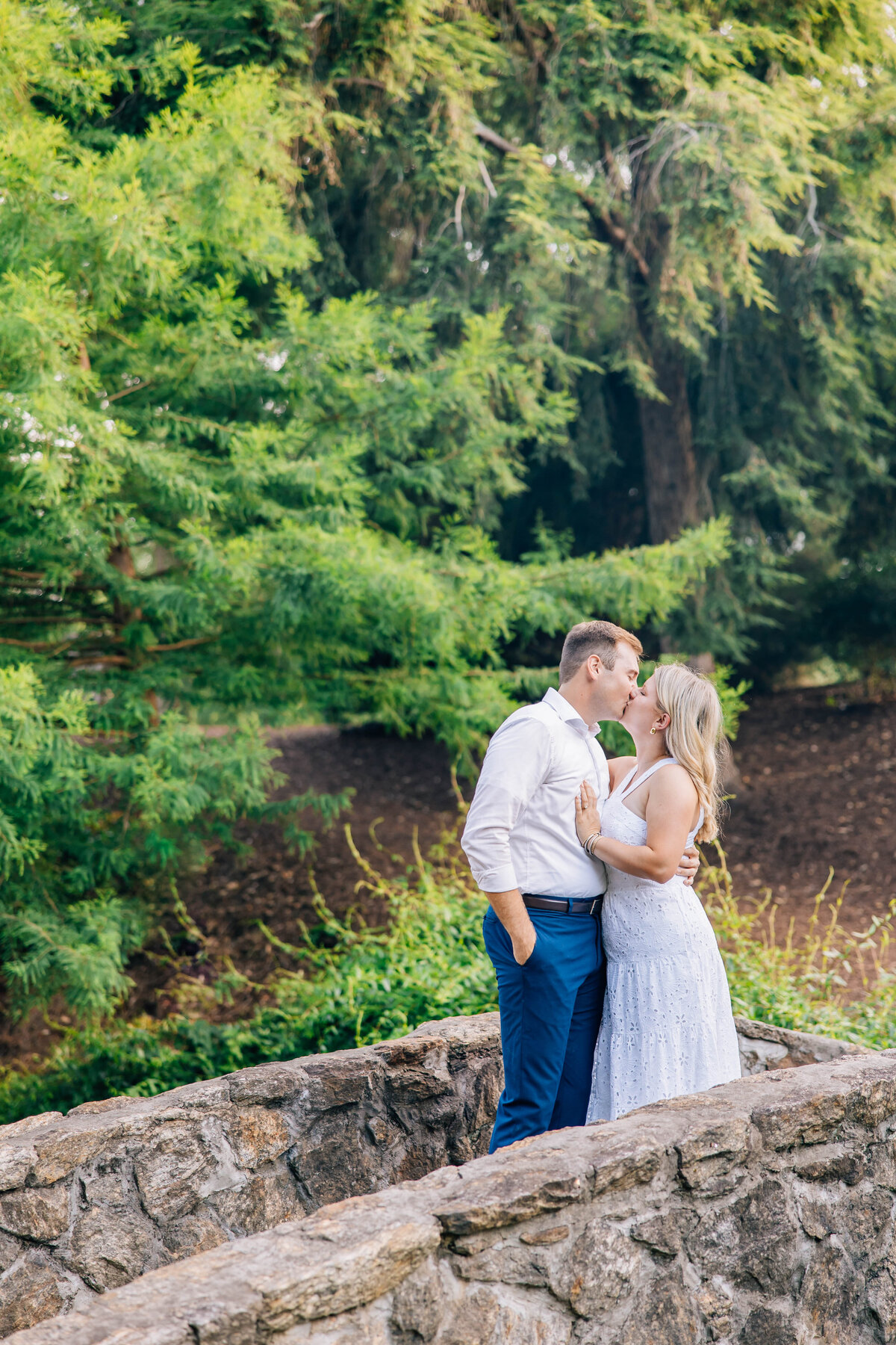 couple kissing on the bridge at the rock quarry