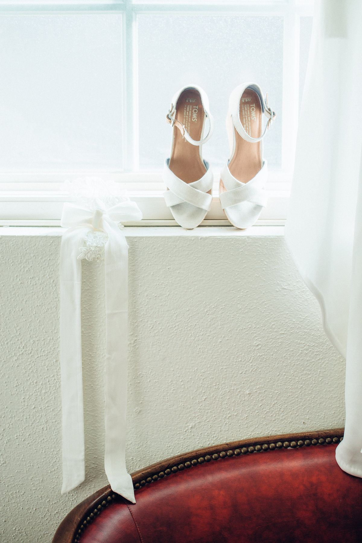 Wedding Photograph Of White Wedding Sandals in Window Los Angeles