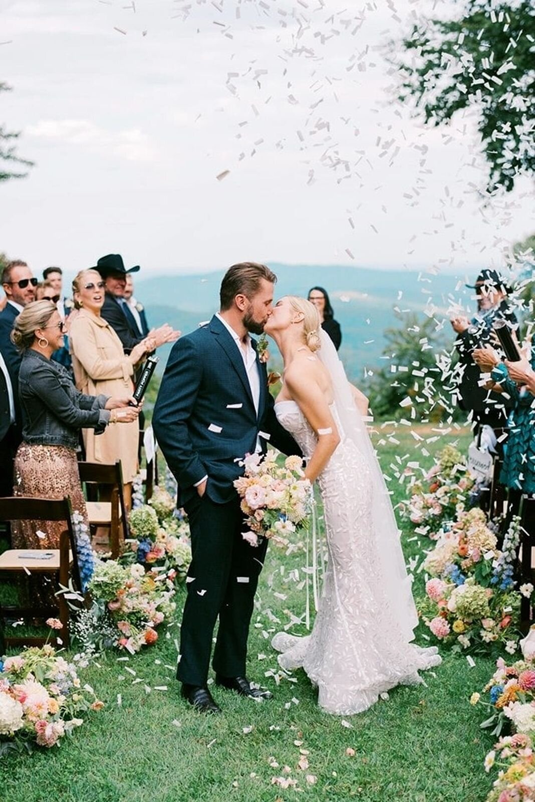 Stunning bride and groom kiss while walking back down the aisle after taking wedding vows