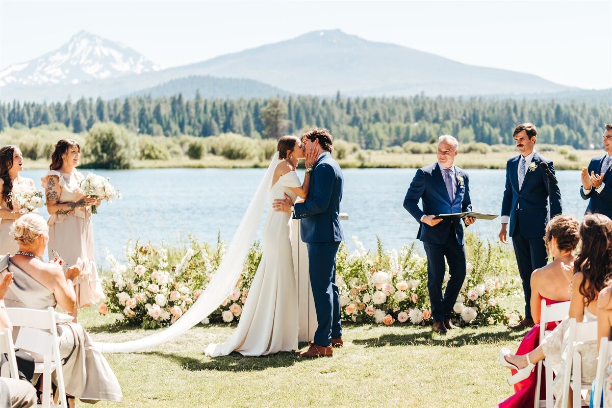 Wedding ceremony in front of pastel flower ground arch at Black Butte Ranch Oregon