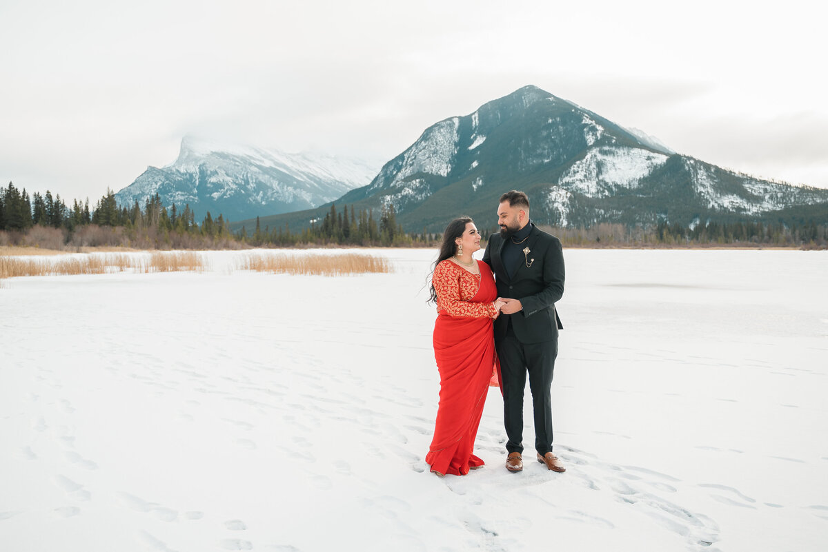 Groom-to-be holds fiancée’s hands during Banff engagement session.