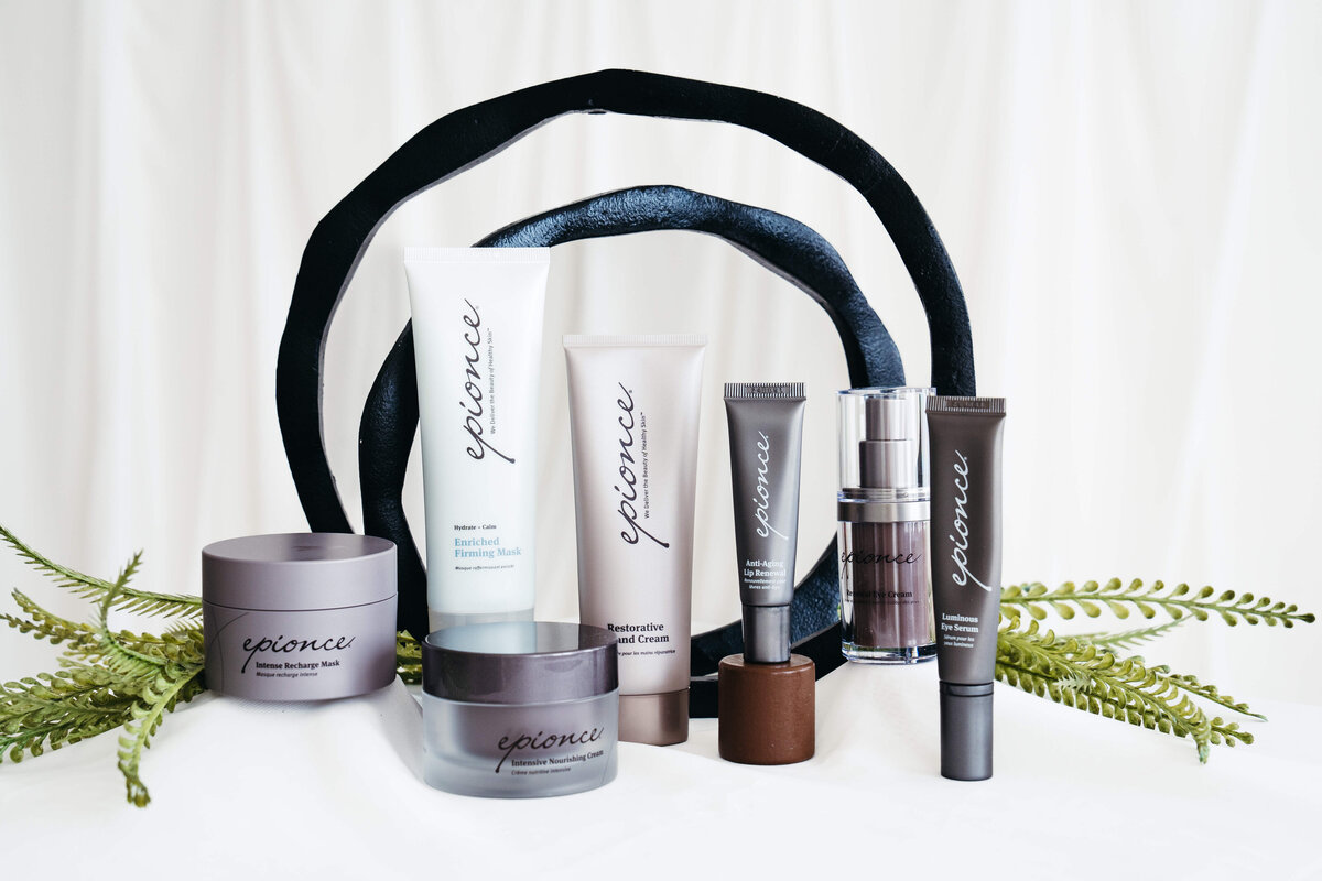 Expanded display of Epionce products including masks, creams, and serums arranged with ferns at Maxwell Aesthetics Salem