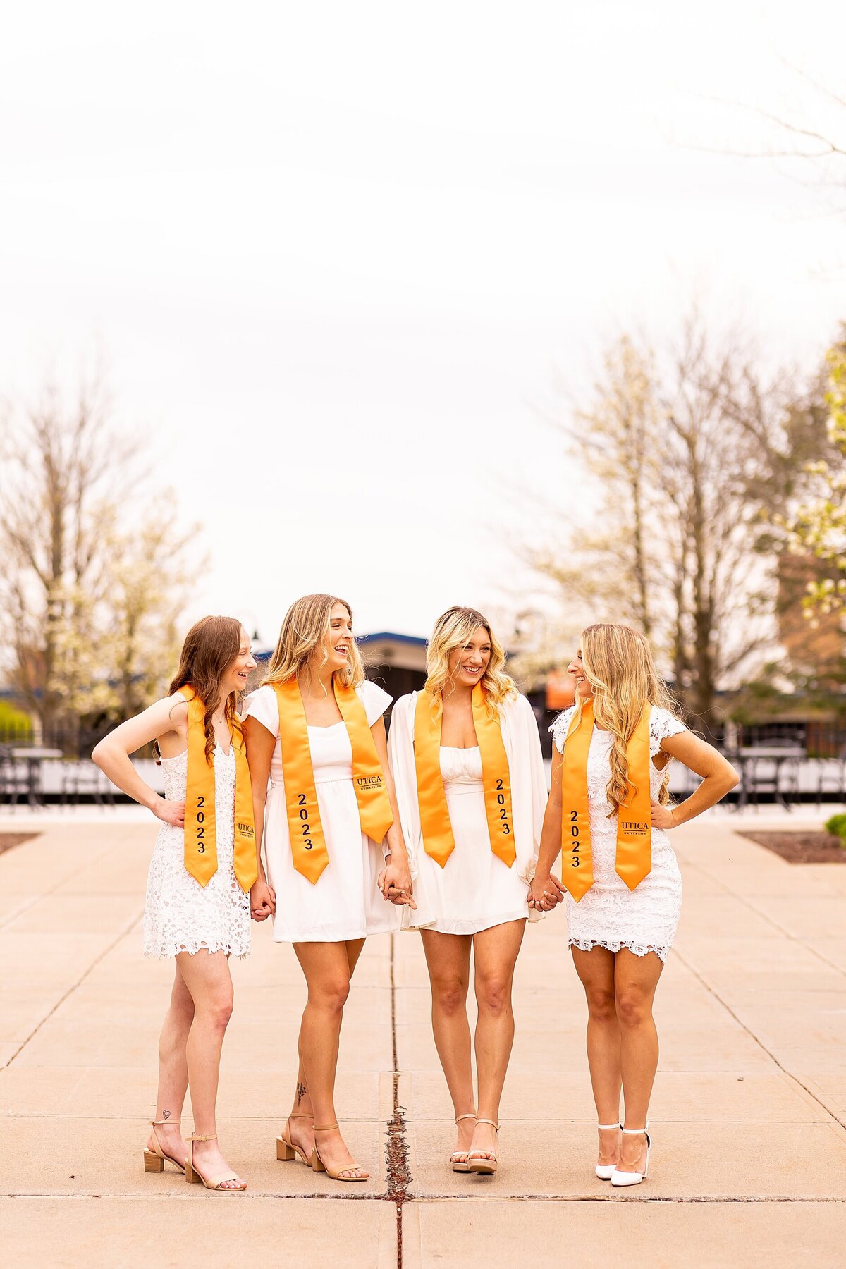 Lifestyle portrait of graduates walking and laughing in Charleston, SC for authentic, elevated imagery