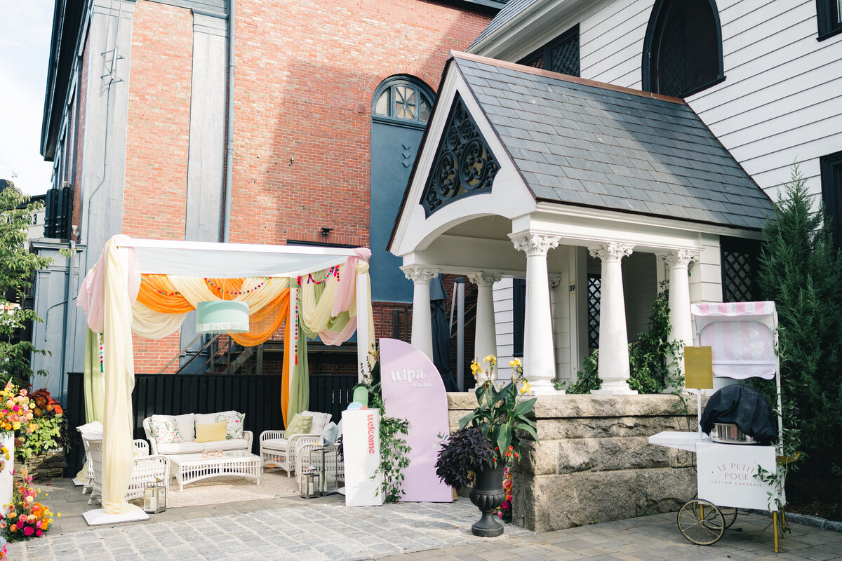 cabana lounge  structure, fabric on pergola, colorful fabric swags, disco balls, sea green drum shade