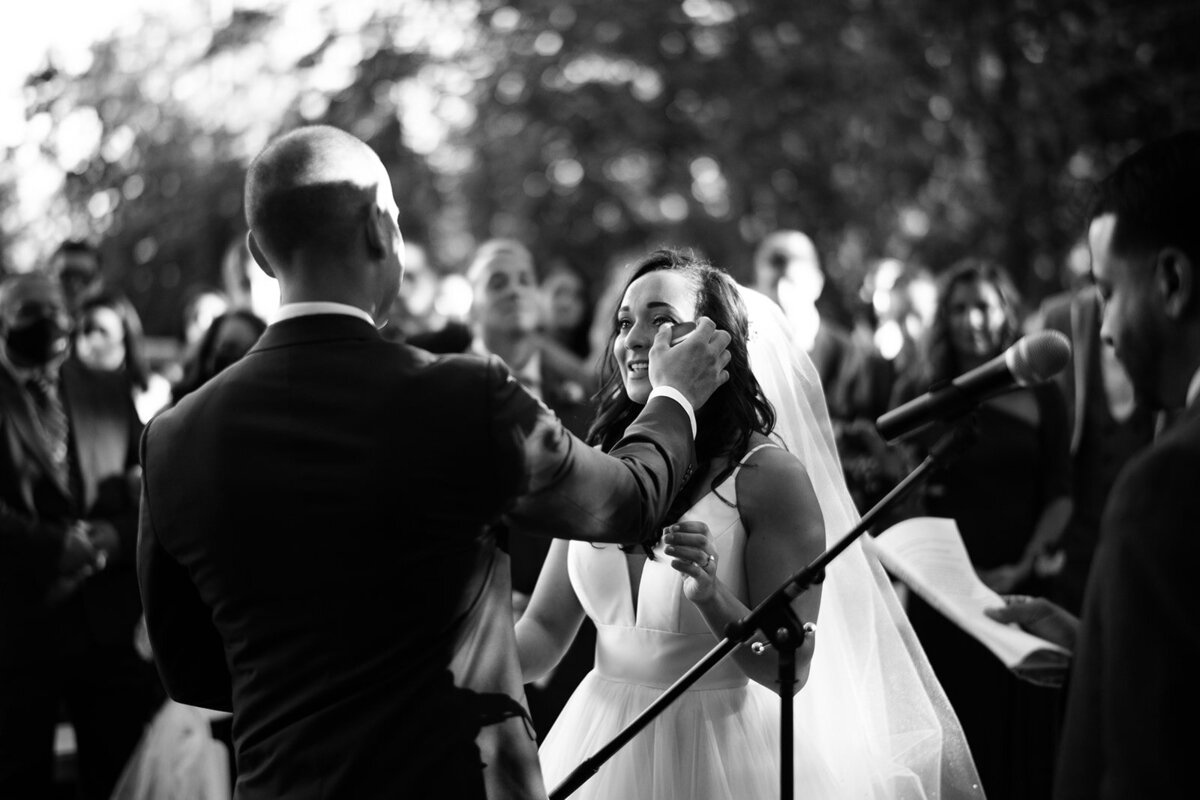 groom wipes tear off brides cheek at their ct wedding photo by cait fletcher photography