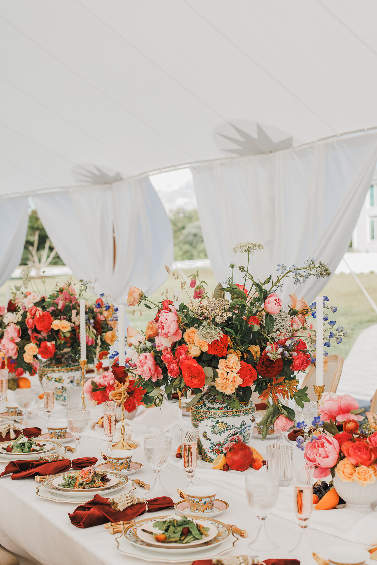 Tablescape with bright florals under the sailcloth tent