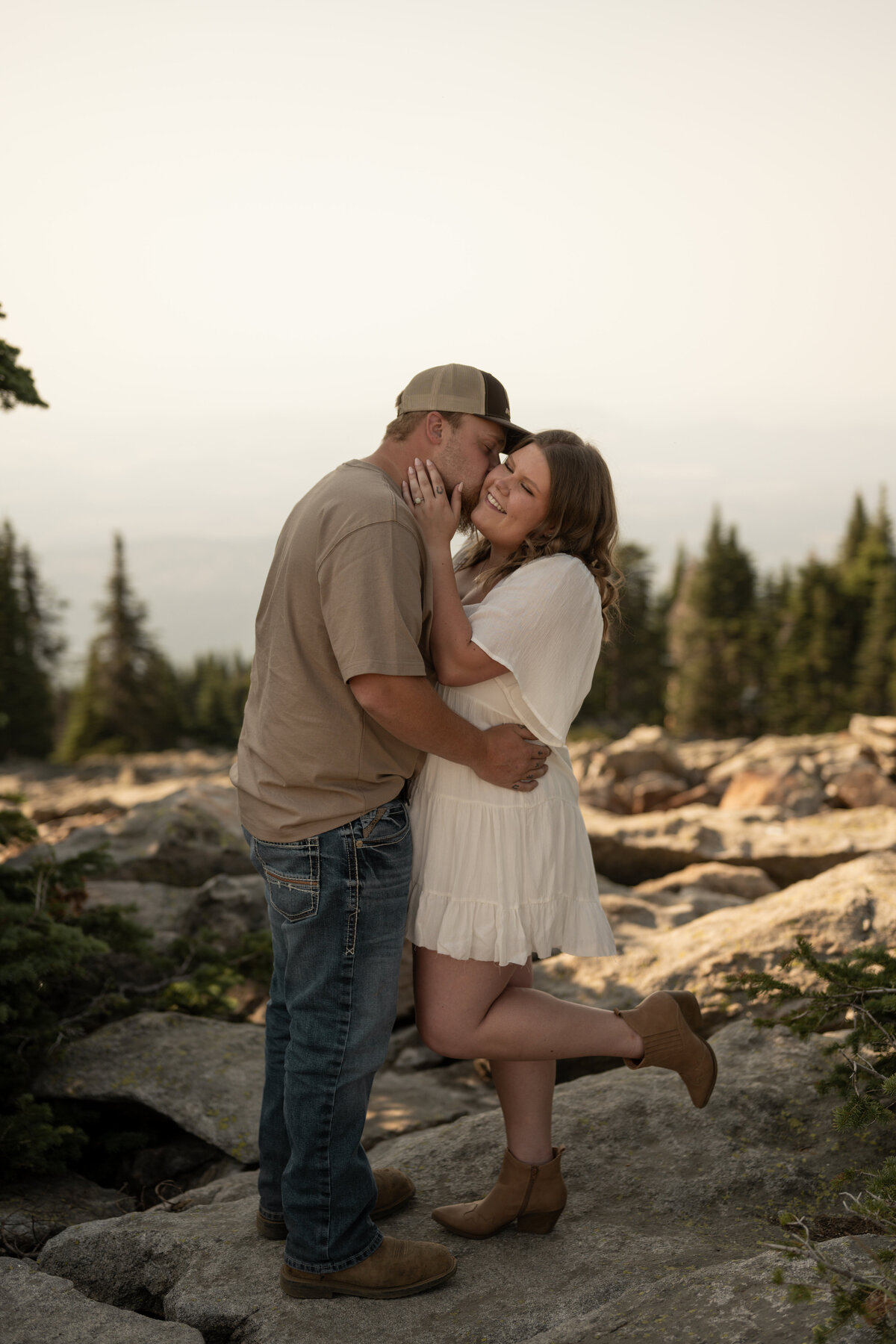 engaged couple posing on a mountain taken by photographers in idaho