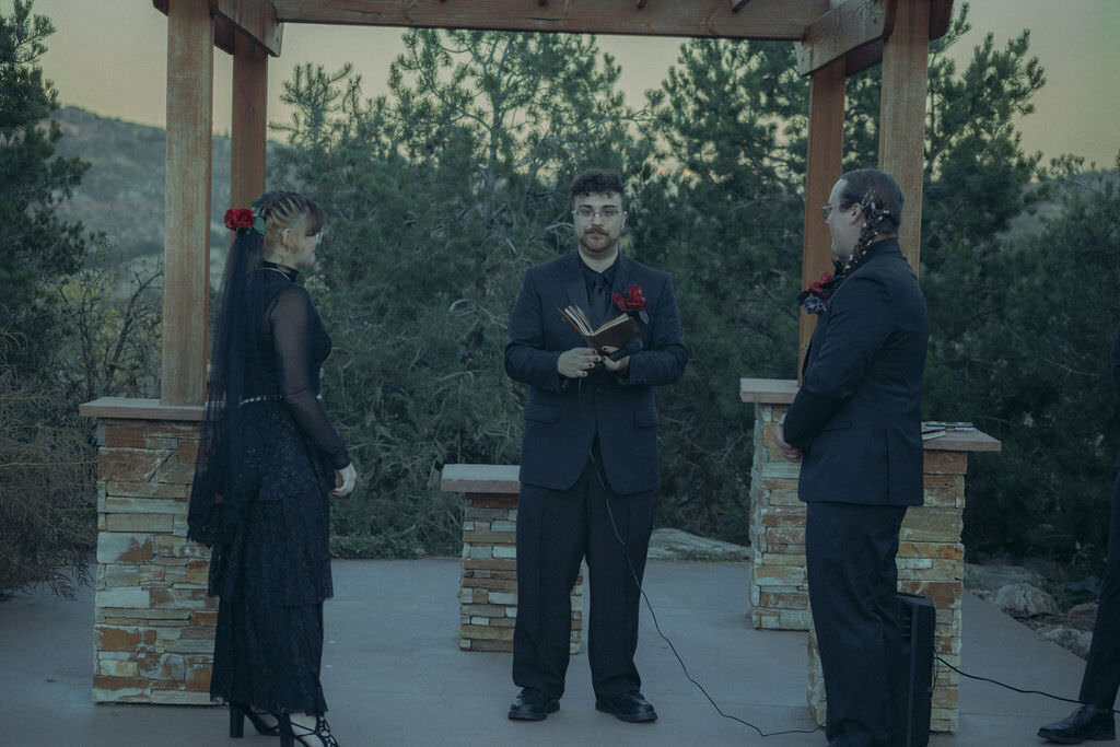 A wedding couple saying their vows together.