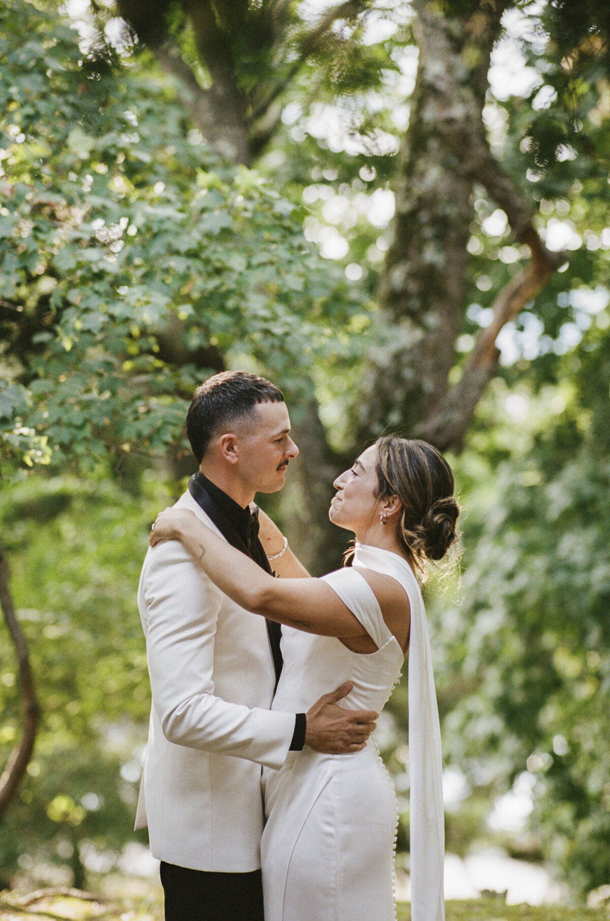 Couple smiling at each other after their first kiss during their Tarrytown House Estate micro wedding shot on 35mm film