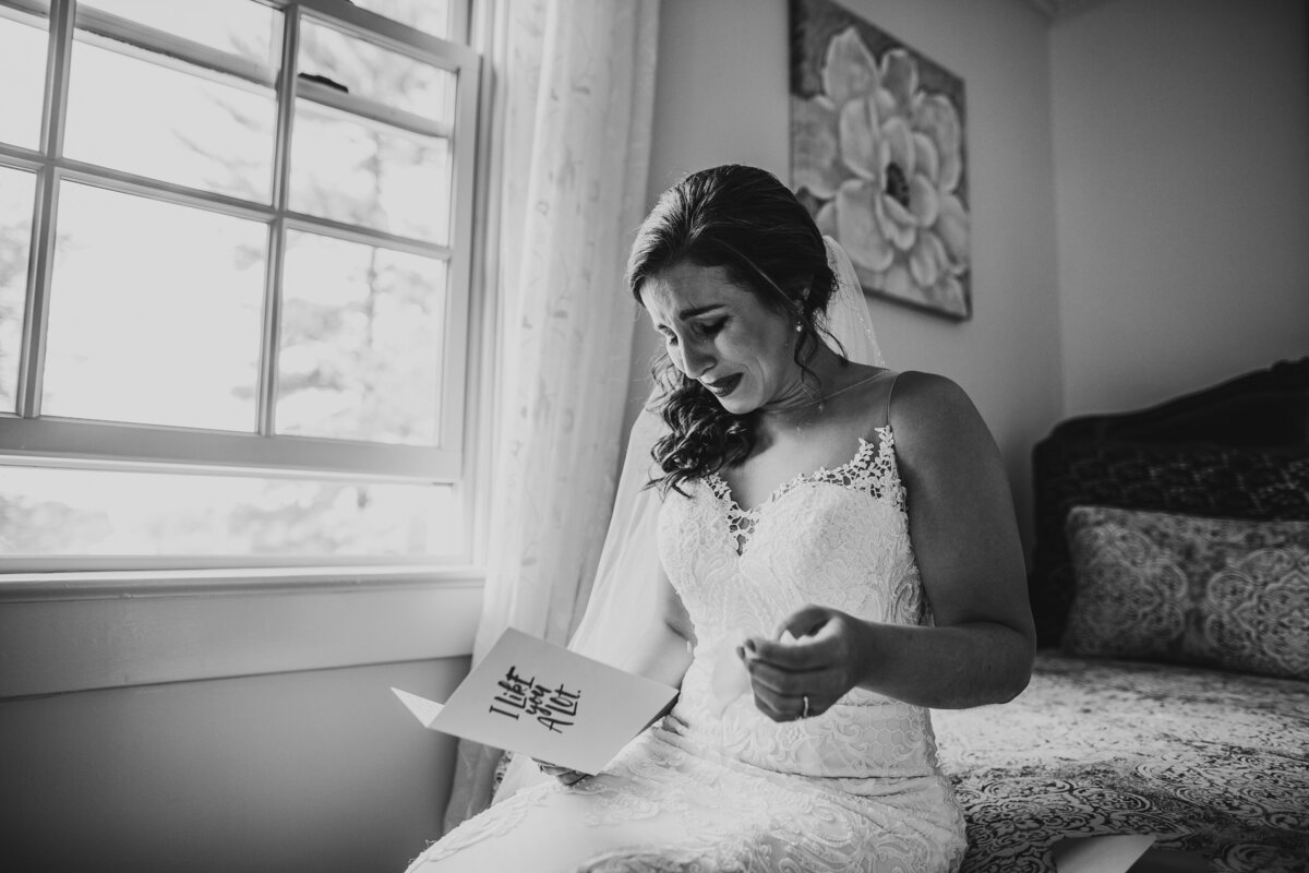 Wedding Photographer,  bride tearing up reading letter