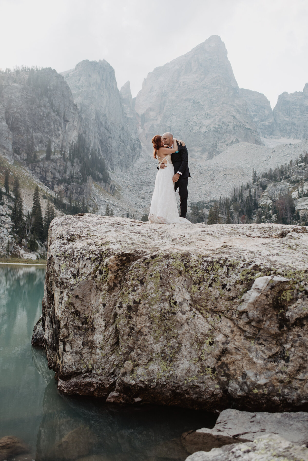 Jackson Hole photographers capture bride and groom hugging as husband and wife