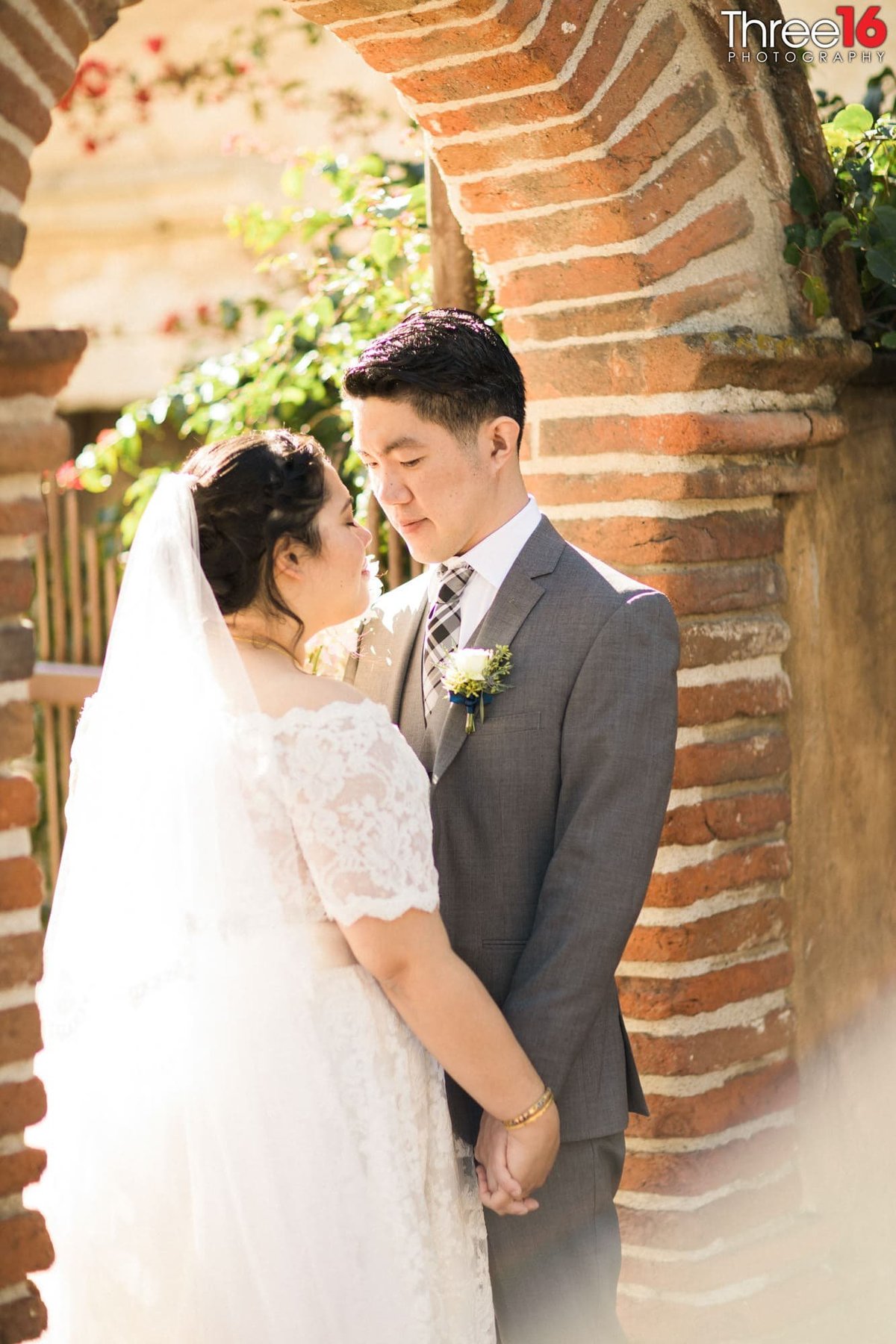 Bride and Groom hold hands as they pray together