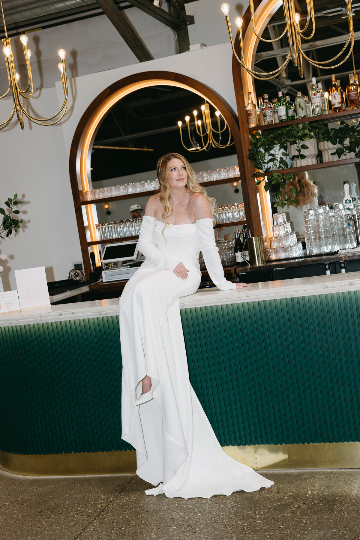 A stunning bridal portrait captured by a Madison wedding photographer at the iconic bar at The Tinsmith, showcasing the bride's elegance against the venue's stylish backdrop.