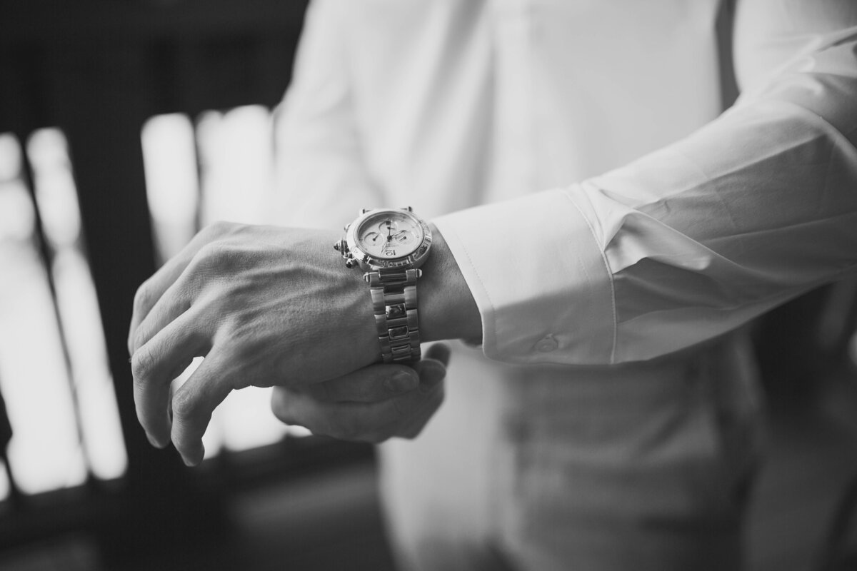 groom putting on watch