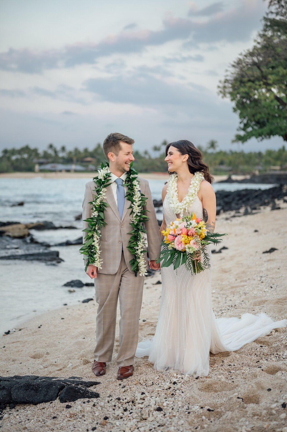 Couple walking at the beach during sunset in Hawaii