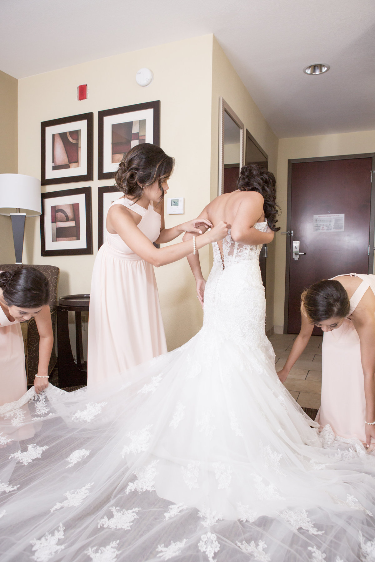 The bride gets ready for her wedding day with the help of her bridesmaids.