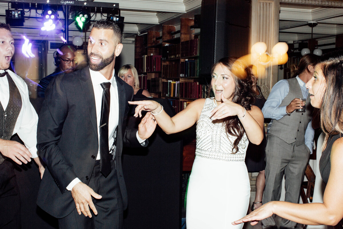 Bride and groom having fun at reception.