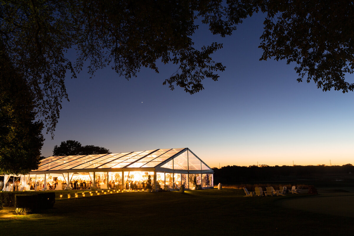 An evening photo of the tenant all lit up with guests inside. 