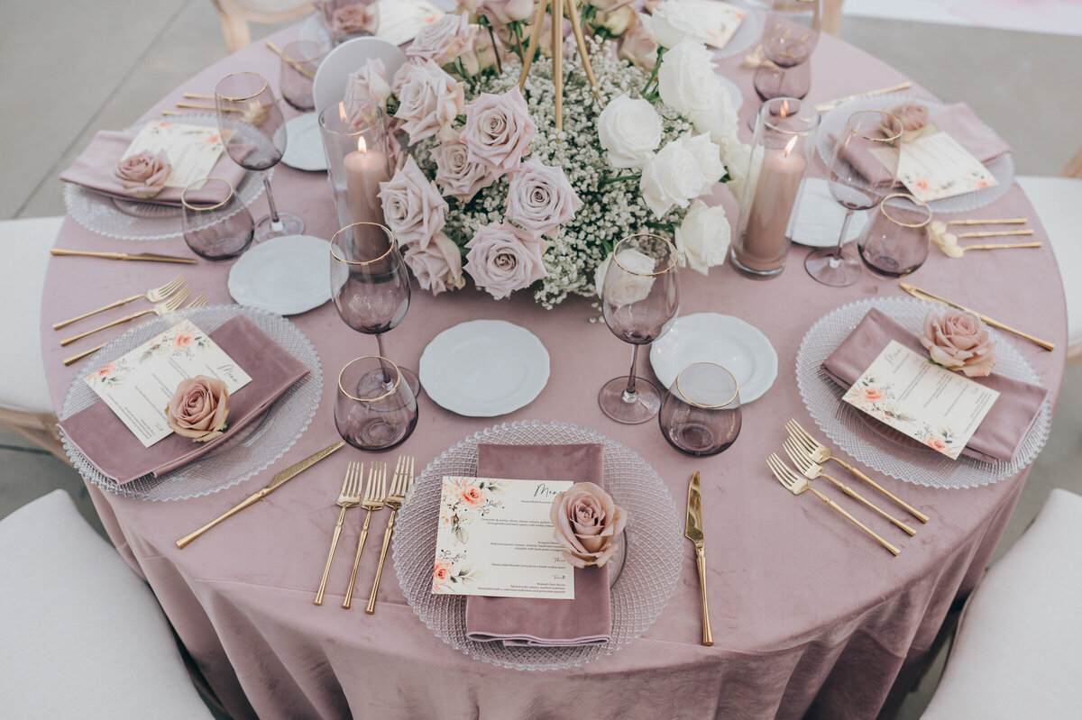 Luxurious wedding table scape featuring lavender glassware and gold cutlery