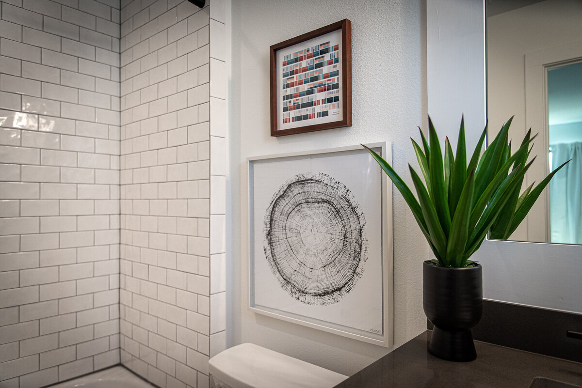 white subway tile shower with gray countertop vanity