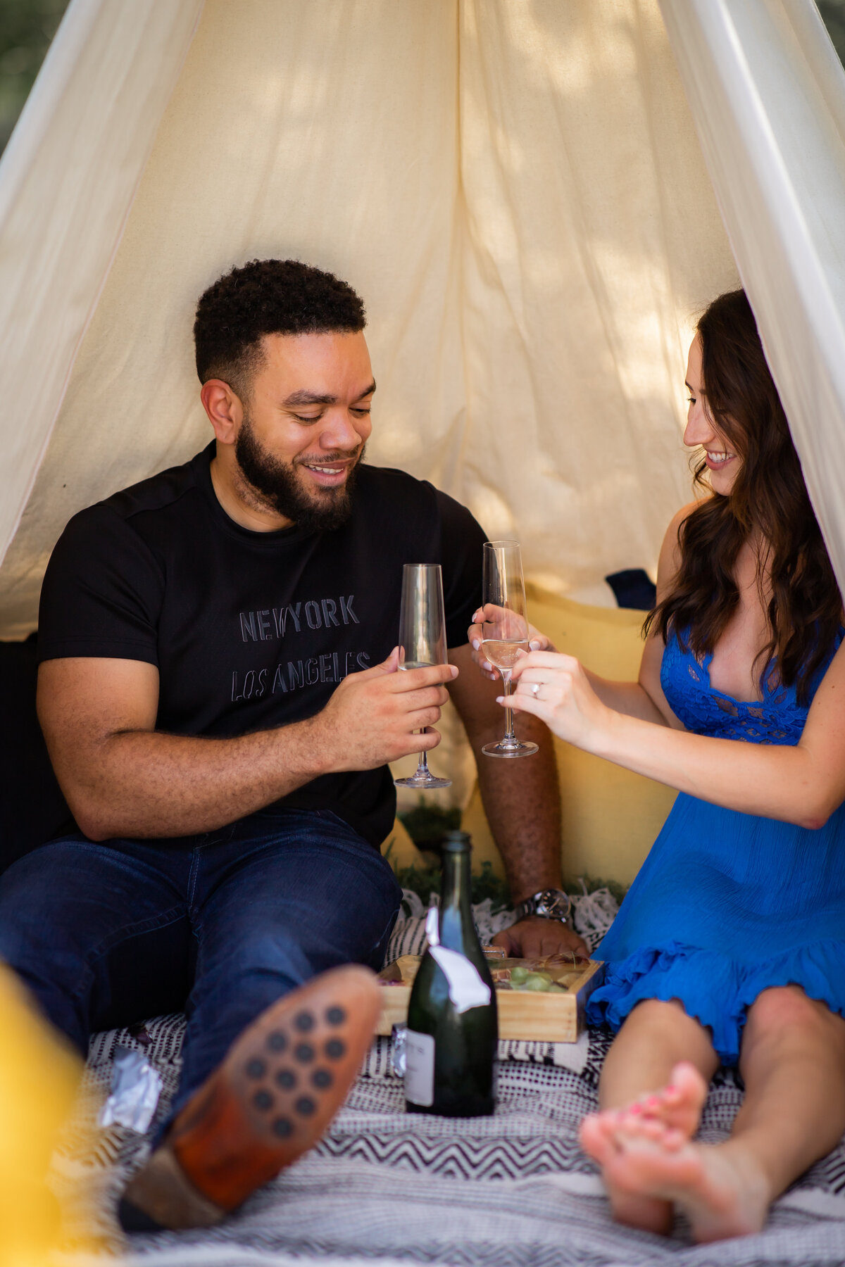 Proposal planning ideas in Austin couple toasting glasses of champagne