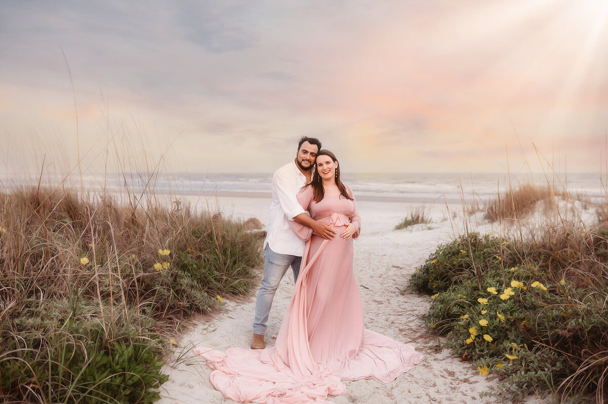 During their Babymoon in Charleston, expectant parents pose for Beach Maternity Photos in Charleston, SC.
