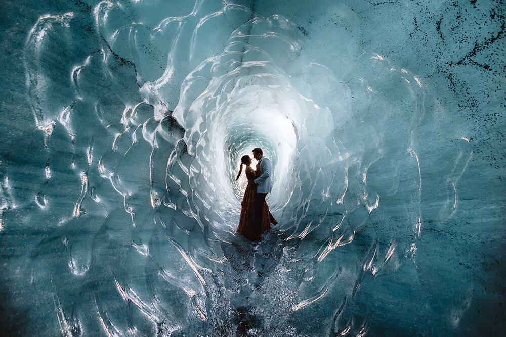 married couple is hugging in an ice cave on their wedding day in iceland