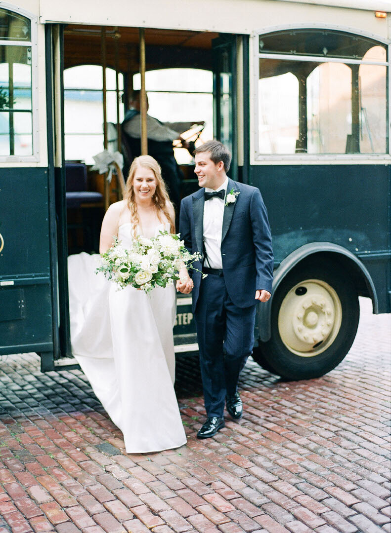 Bride and Groom Getting Off Trolley Photo
