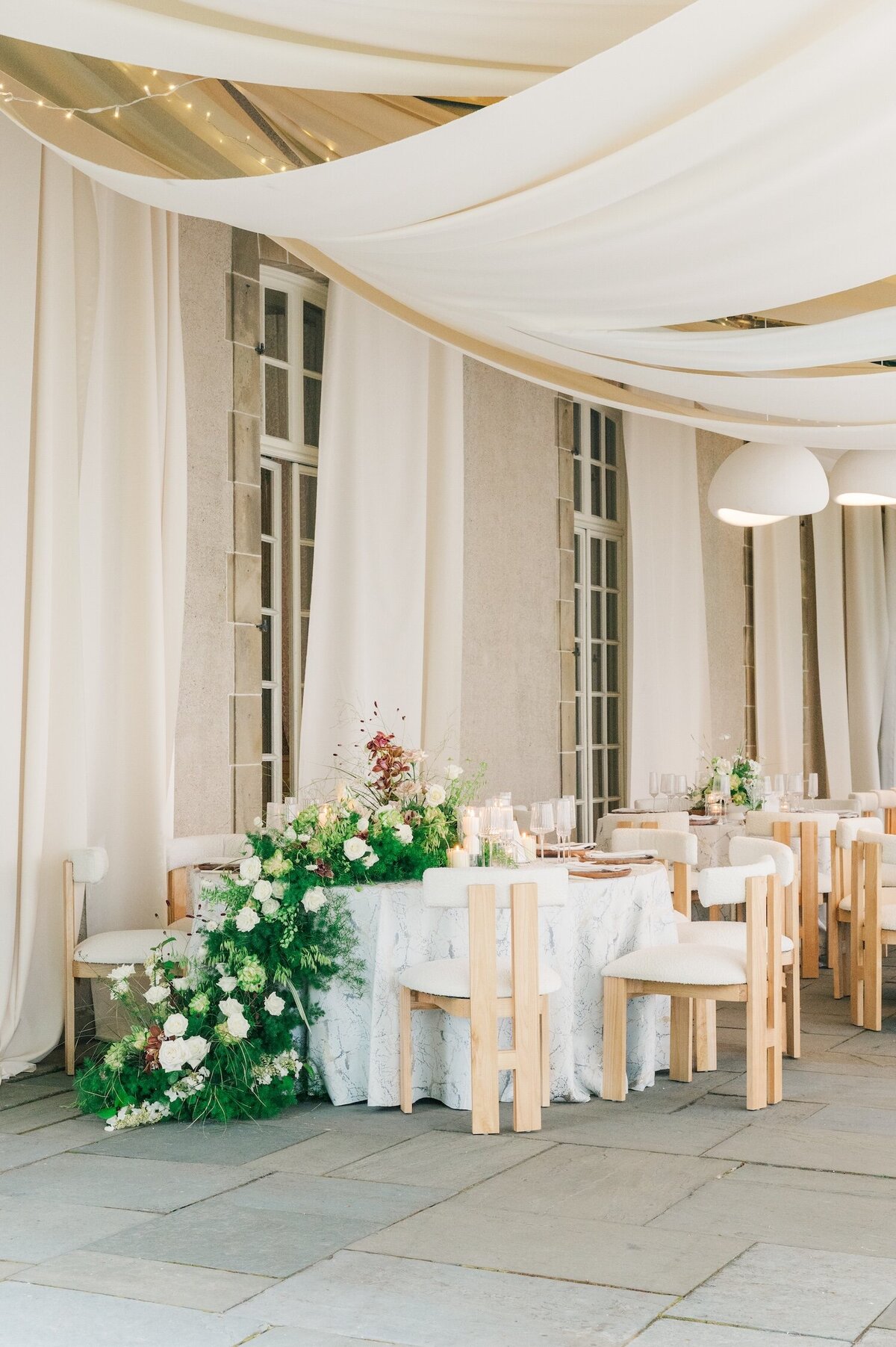 A cascading whimsical floral display on a white tablecloth at Glen Manor House. 