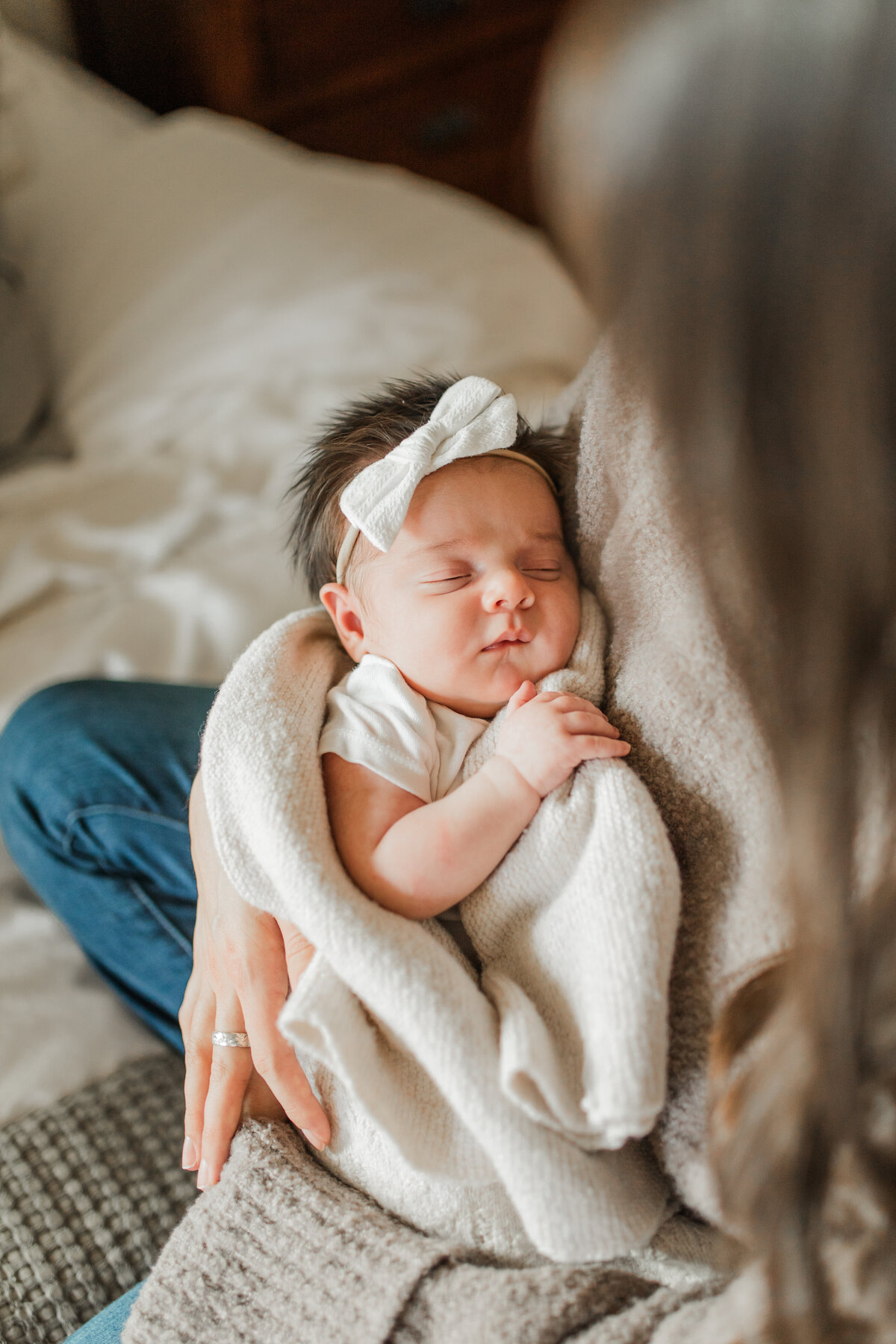 Newborn baby sleeping on a white blanket