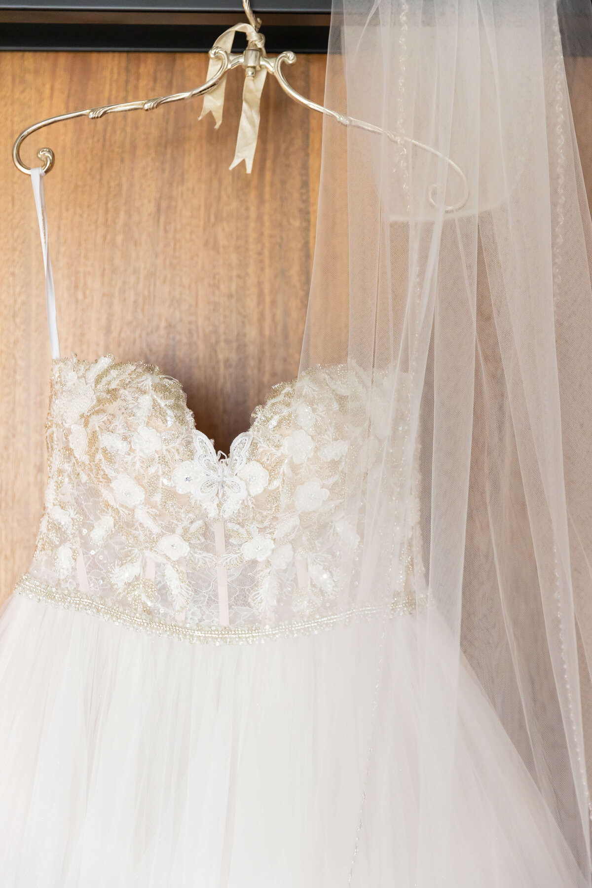 Lace wedding dress hung up with veil