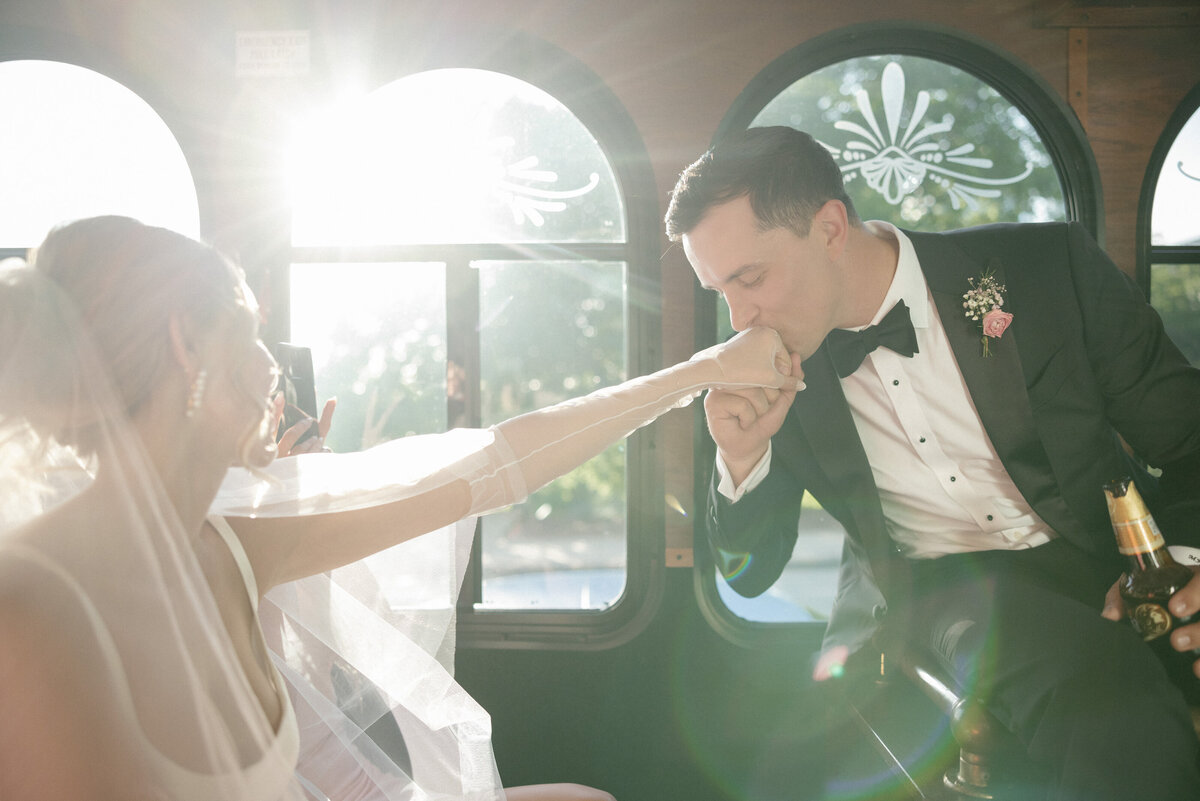 groom kissing brides hand