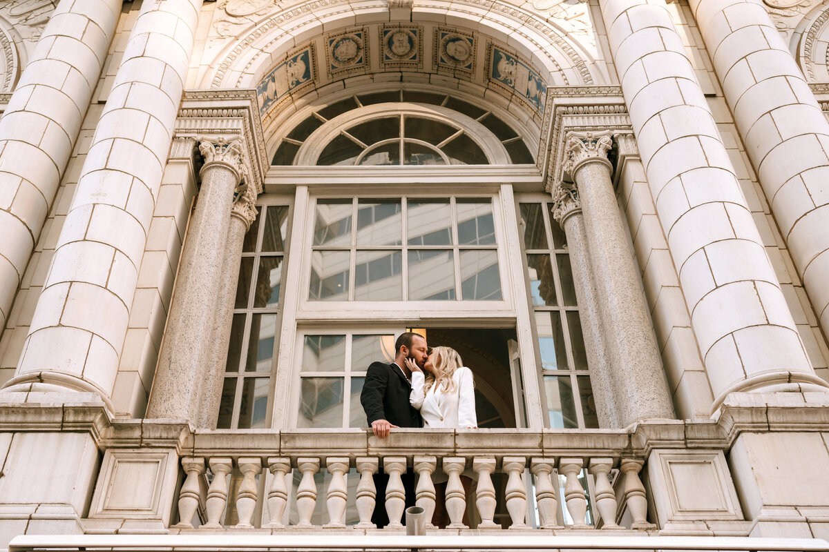 newlyweds kiss on balcony