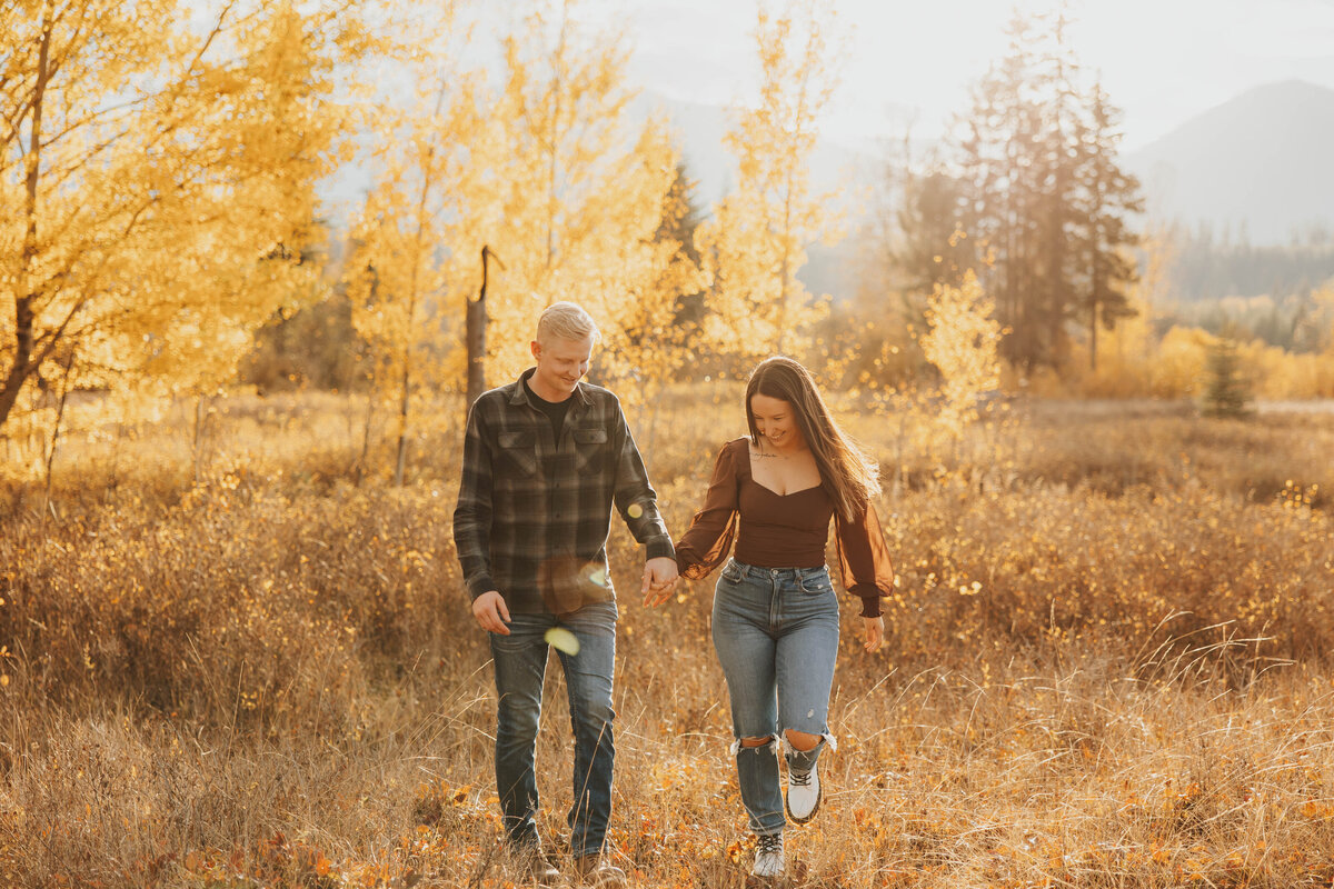 couple holding hands in forest