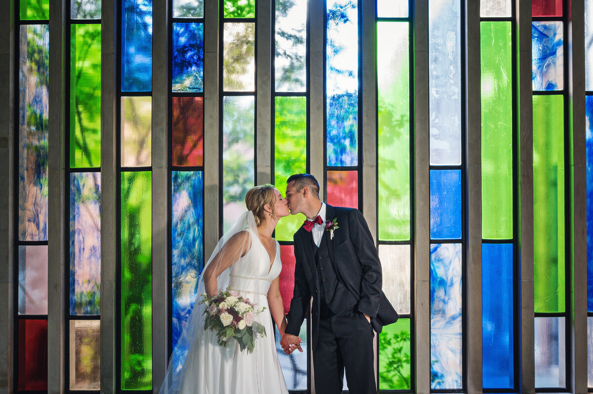 Wedding photos by stained glass window.