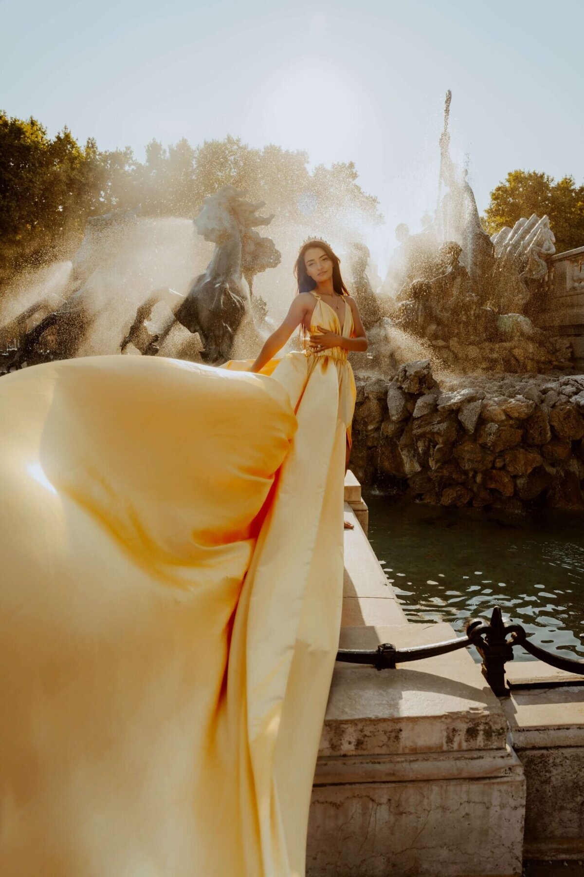 women having a portrait photoshoot in paris wearing a gold flying dress