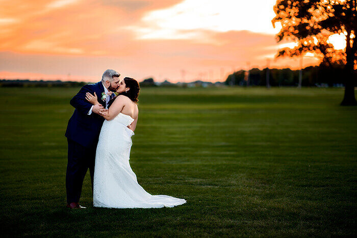 groom-leans-into-bride-sunset-golfcourse