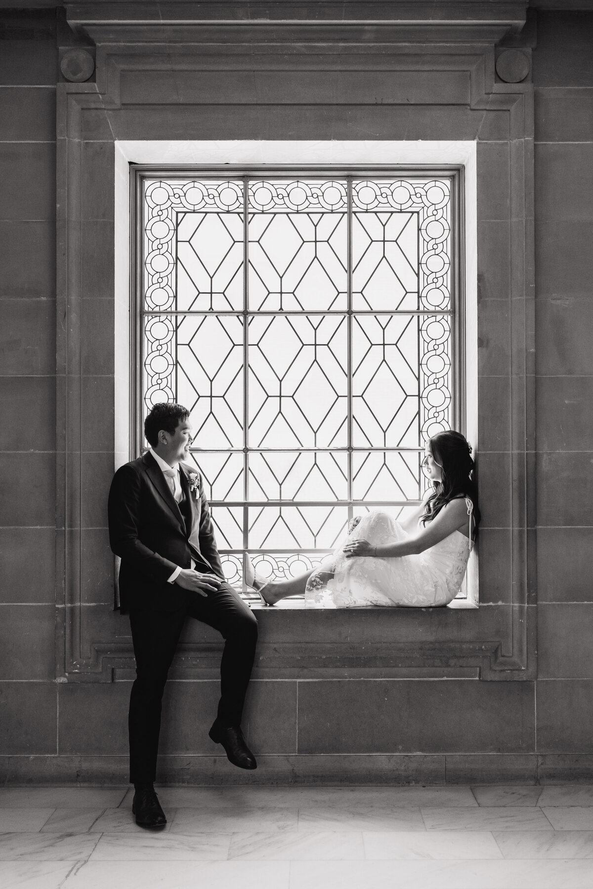 bride and groom sit in city hall