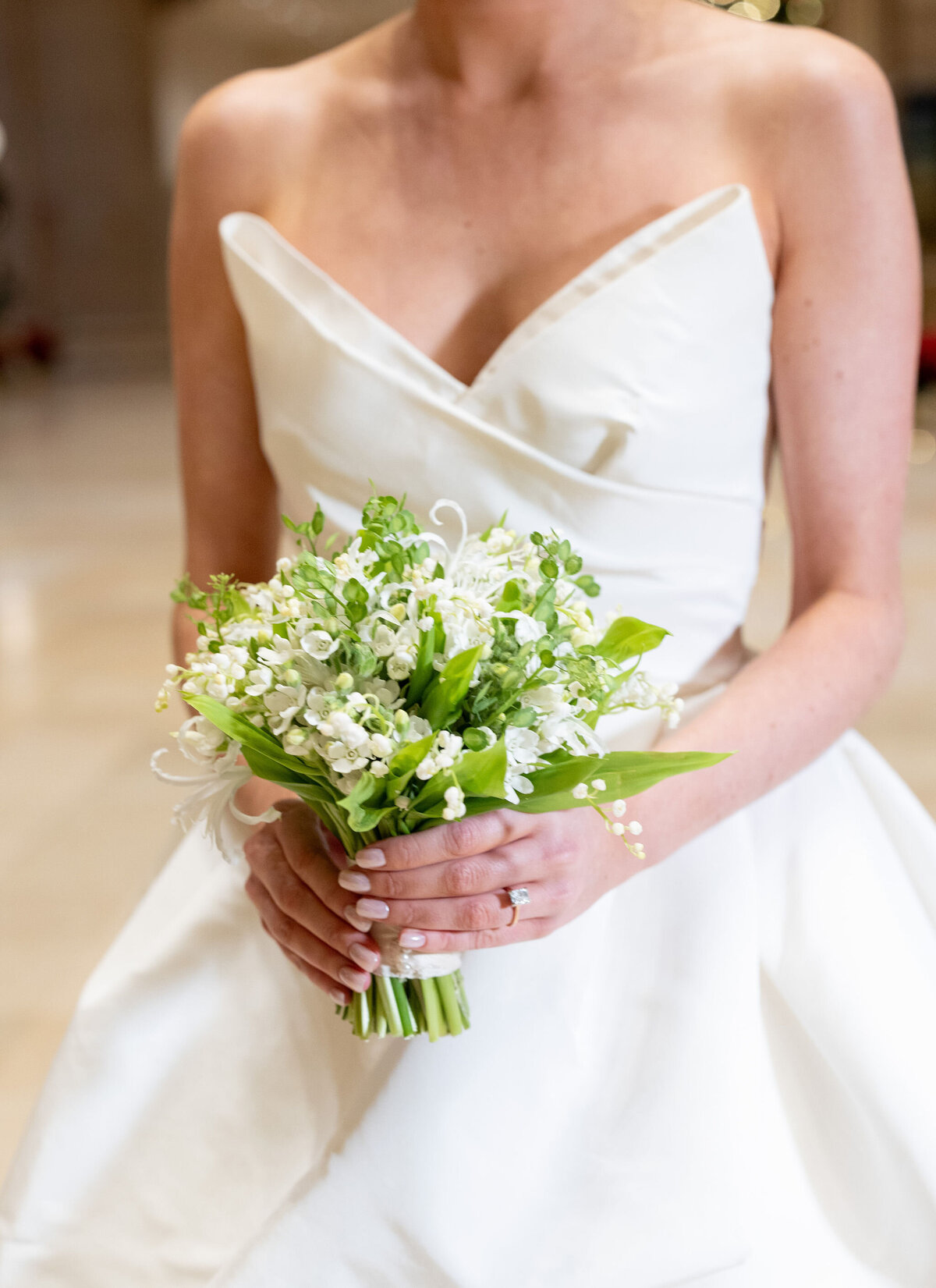 Close up of a bride holding a bouquet of flowers. 