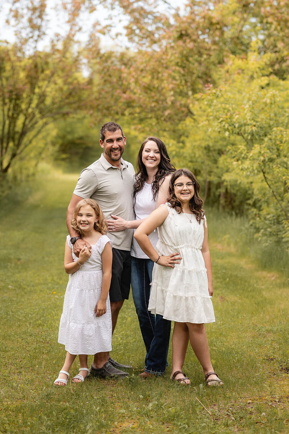 Beautiful family of four during their outdoor family photo session done by Jennifer Brandes Photography.
