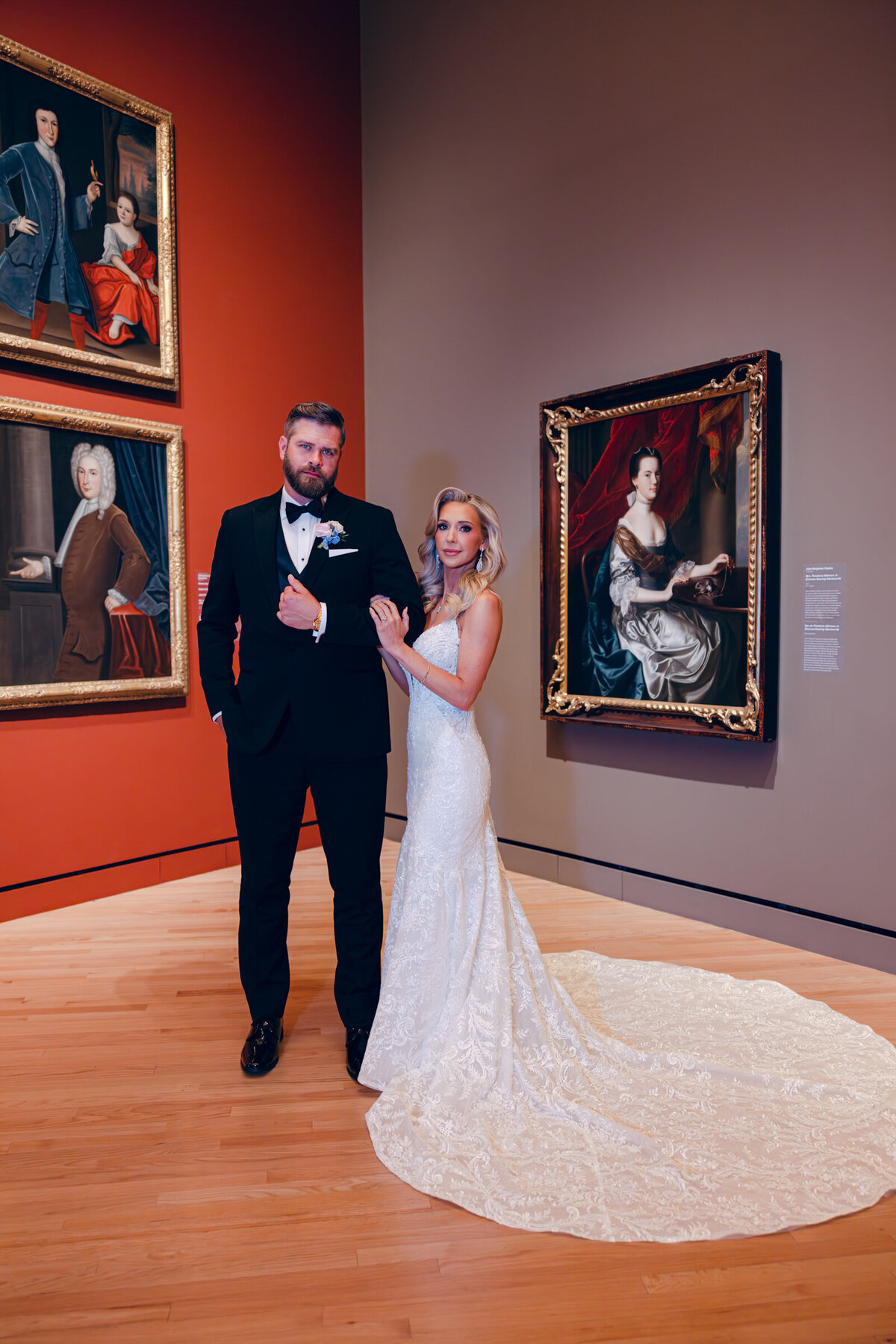 A wedding day photo  of the bride and groom posing for a portrait in Crystal Bridges Museum of American Art in Arkansas