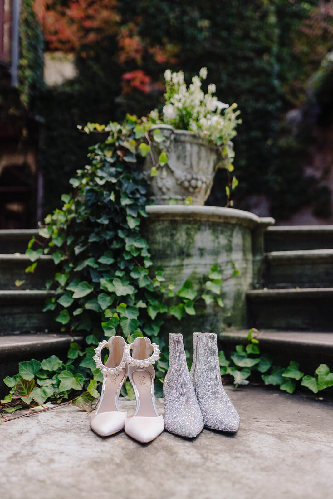 Brides shoes and boots beside a fountain