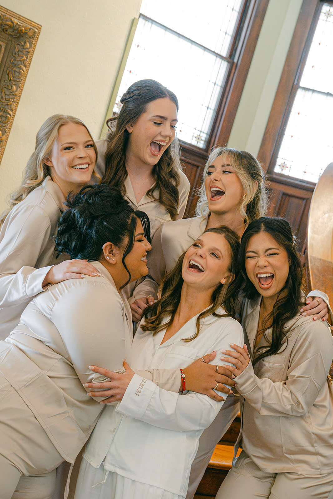 Bridesmaids laugh and celebrate with bride before wedding at a luxury estate wedding venue in San Antonio